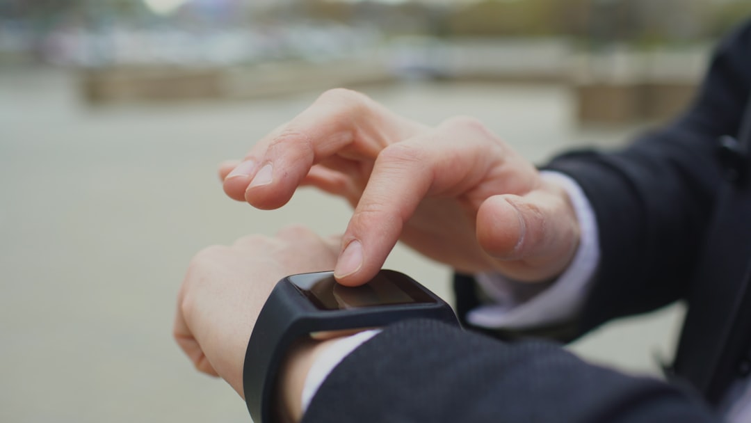 A person using a smartwatch outdoors - trending tech gadgets 2025
