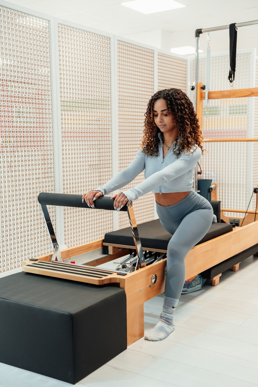 Woman exercising on rowing machine in modern gym for Zone 2 training